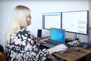 TFS employee pictured working at their office desk